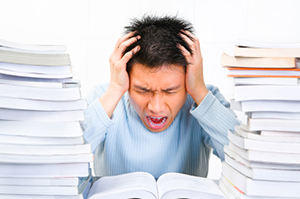 A young scholar is screaming stressfully while studying